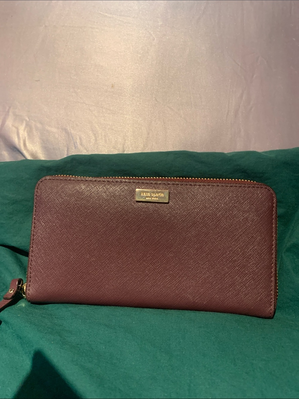 kate spade zip-around wallet in burgundy with gold hardware